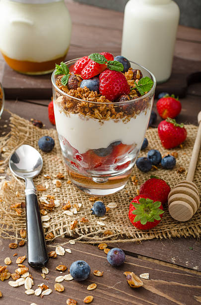 istock Yogurt with baked granola and berries in small glass 485041622