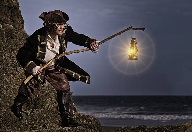 istock pirate with lantern standing on rocks at beach 485042864
