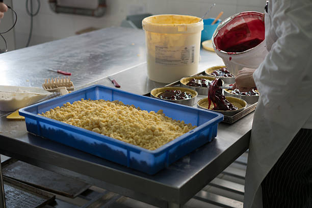 istock Putting Cherry Filling in Cheese Cakes 485045126