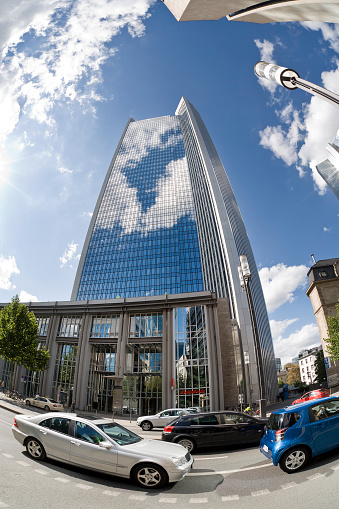 Frankfurt, Germany - August 15, 2011: Low-angle view of DekaBank skyscraper in the financial district of Frankfurt, Germany. DekaBank is the central asset manager of the Sparkassen in Germany and was founded in 1956. DekaBank is one of the largest asset managers in Germany. In the foreground cars and city traffic on Mainzer Landstrasse