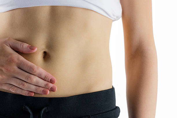 istock Slim woman touching her belly 485046282