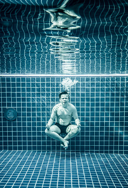 istock Persons lies under water in a swimming pool 485046638