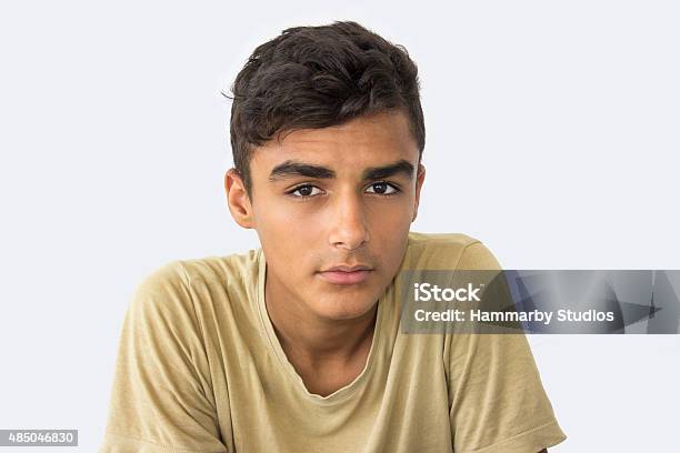 Teenage Boy Looking At Camera With Blank Expression Stock Photo - Download Image Now