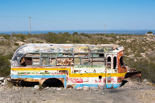 istock Rusted out old school bus abandoned in the countryside 485046900