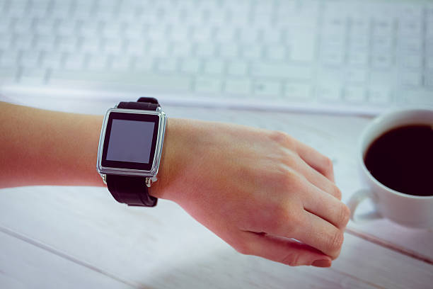 istock Woman using her smartwatch and phone 485047122