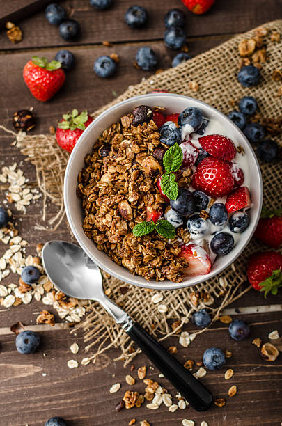 istock Yogurt with baked granola and berries in small bowl 485047186