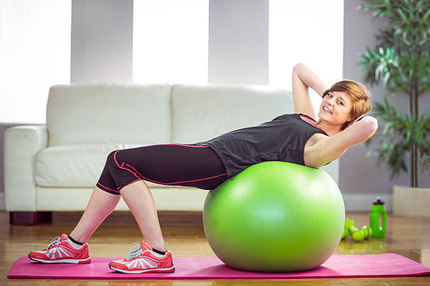 istock Fit woman doing sit ups on exercise ball 485048278