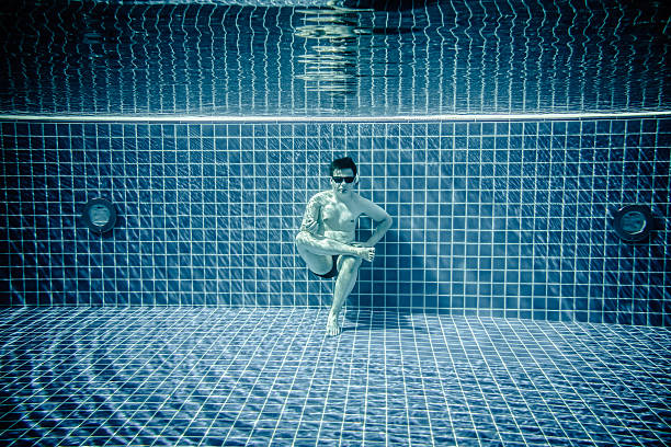 istock Persons lies under water in a swimming pool 485051254