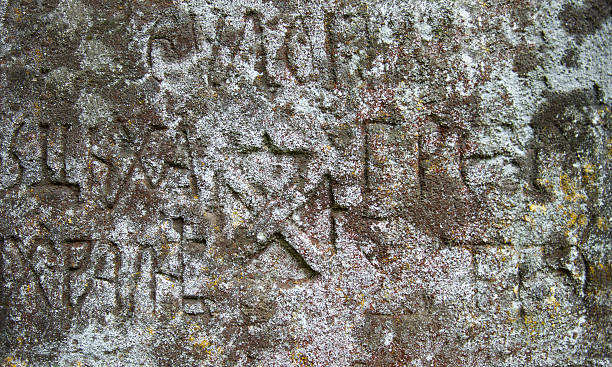 istock Moss-grown surface of the old stone cross 485053768