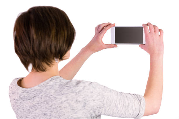 istock Pretty brunette taking a picture with her smartphone 485054340