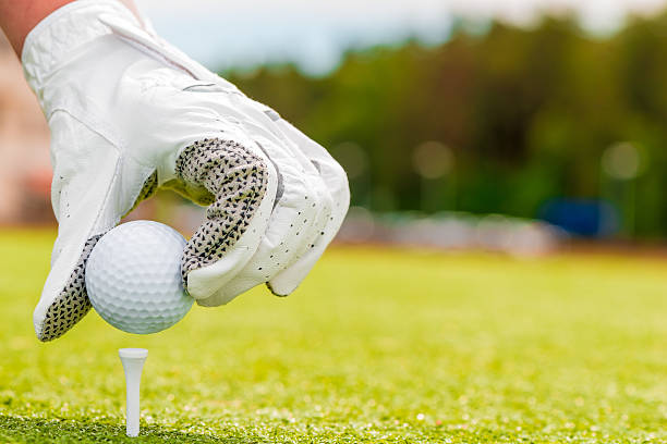 istock macro shooting hand in a glove and golf ball 485056938