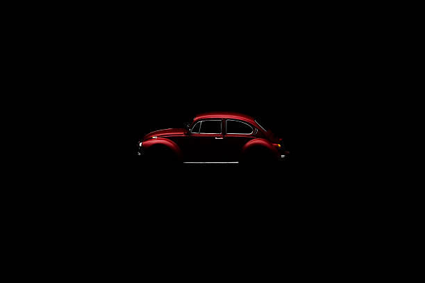 Vw beetle Sebes, Romania - november 06, 2014: Red toy Vw beetle isolated  on black background beetle photos stock pictures, royalty-free photos & images
