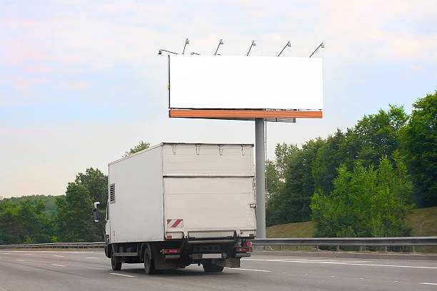 istock truck goes on highway by billboard 485057472