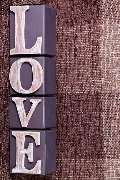 istock word love from cubes on a brown background 485057902