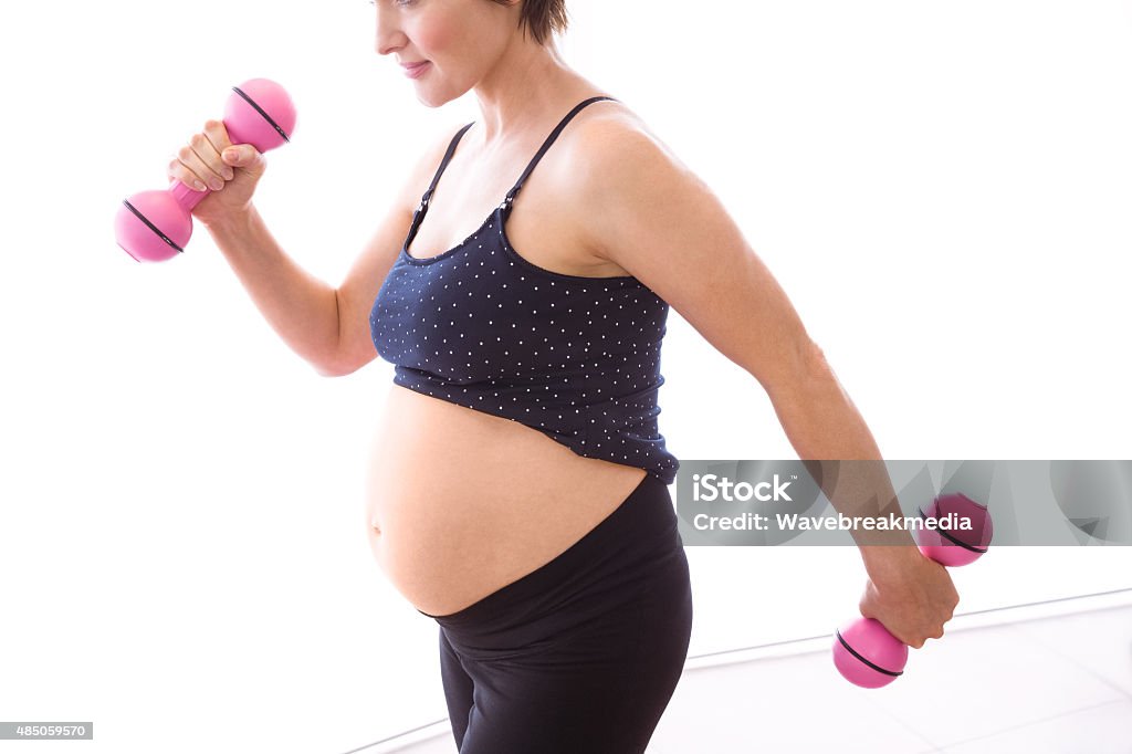 Pregnant woman keeping in shape Pregnant woman keeping in shape at home 2015 Stock Photo