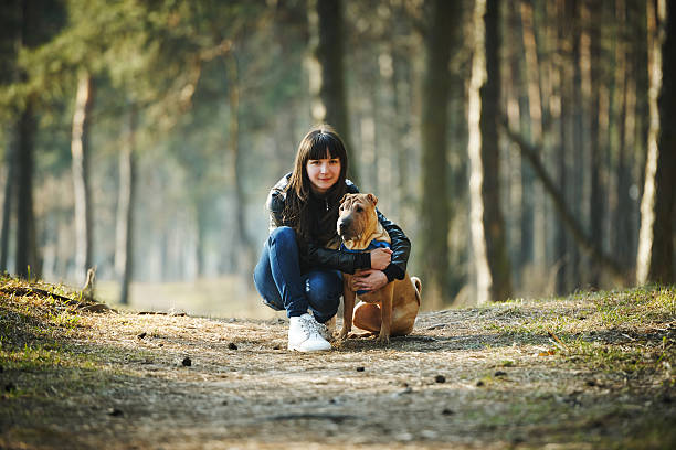 istock girl with dog in the park 485059676
