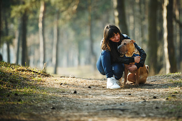 istock girl with dog in the park 485059700