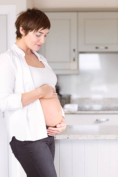 istock Pregnant woman holding her bump 485060264