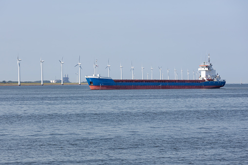 Dutch sea with cargo ship and offshore wind turbines