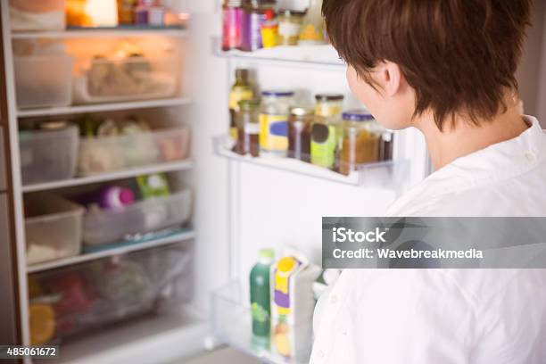 Pregnant Woman Opening The Fridge Stock Photo - Download Image Now - 2015, 40-44 Years, 40-49 Years