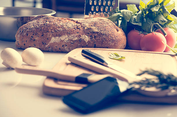 istock Mobile phone in a kitchen with food. 485061746