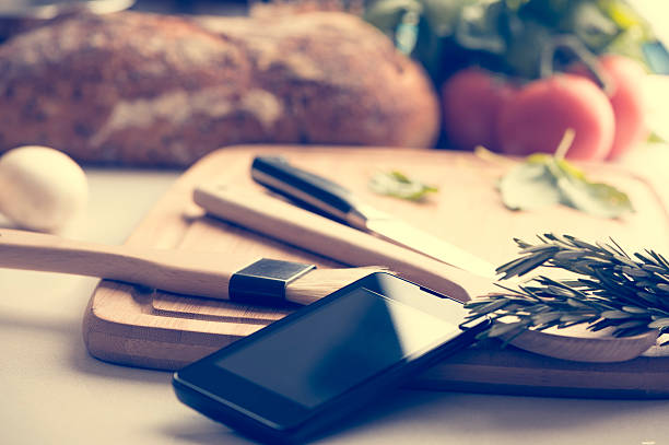 istock Mobile phone in a kitchen with food. 485061748