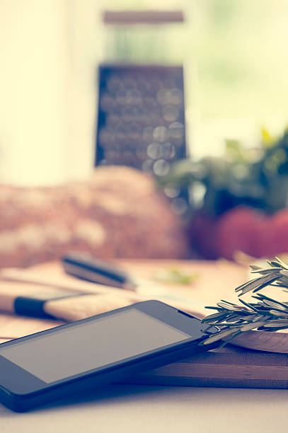 istock Mobile phone in a kitchen with food. 485064966