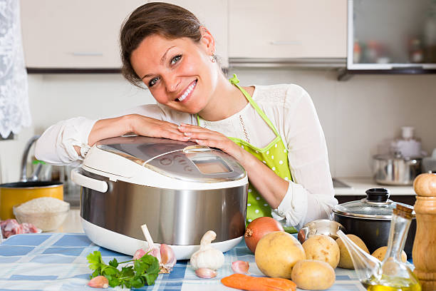 istock Woman cooking with multicooker 485067028