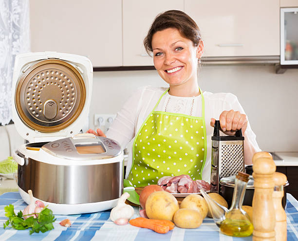 istock Happy  woman using slo-cooker 485067032