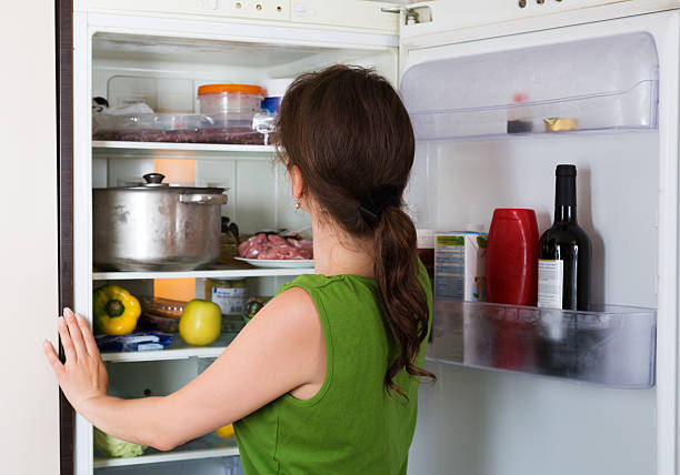 istock Brunette girl looking in fridge 485067092