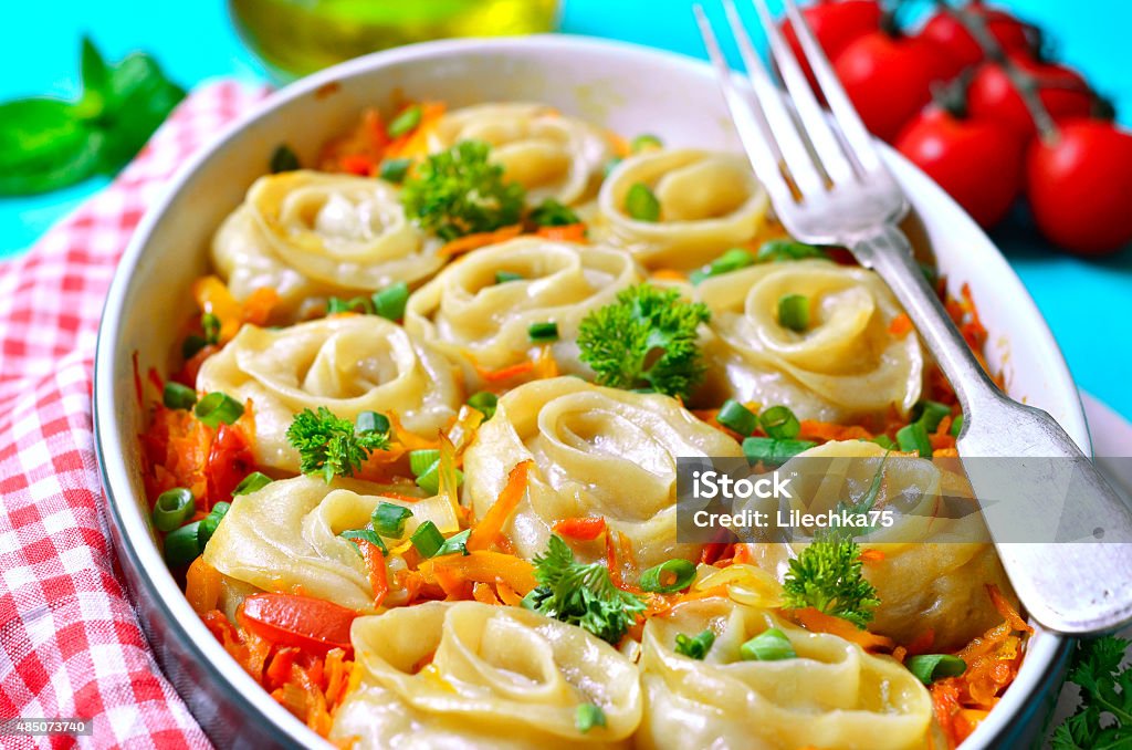 Dumplings "Meat roses". Dumplings "Meat roses" baked in vegetable sauce. 2015 Stock Photo