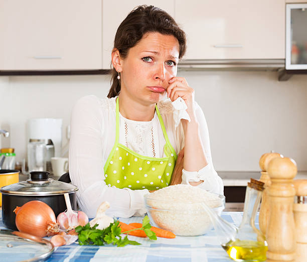 istock Pensive woman cooks rice with vegetables 485076428