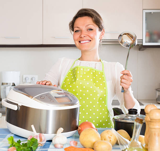 istock Housewife cooking with multicooker 485076438