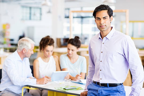 istock Confident Businessman Leaning On Conference Table 485077240