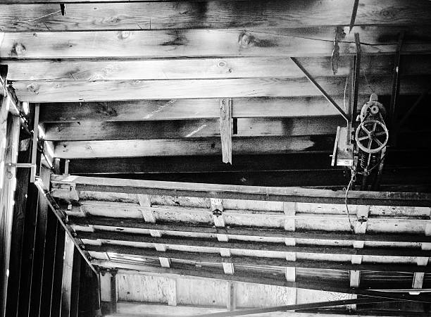 This is an antique industrial garage door opener and wooden garage door in an old abandoned grain mill in Colorado.