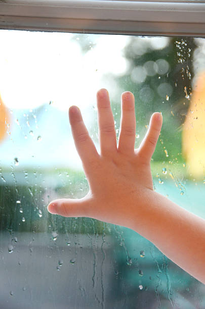 istock Childs hand on the window 485077788