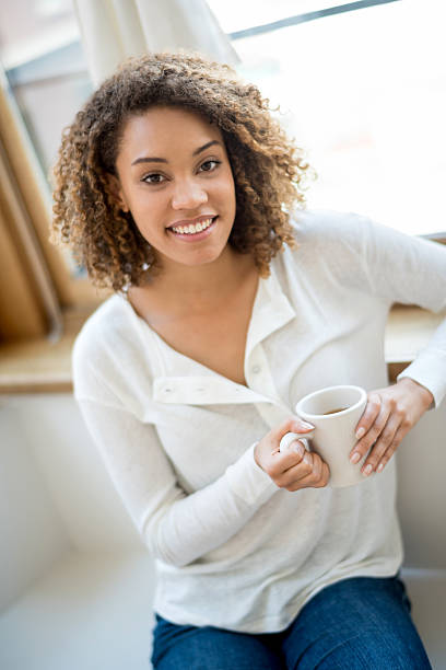 istock Black woman drinking coffee at home 485078328