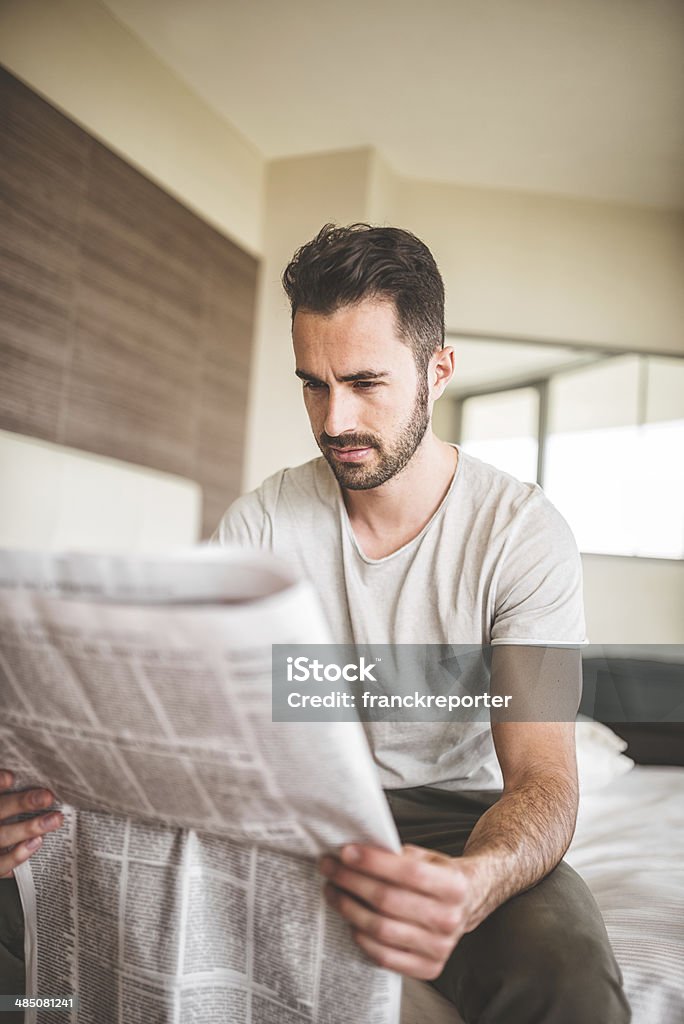 man reading the newspaper on bedroom http://blogtoscano.altervista.org/hor.jpg  Adult Stock Photo