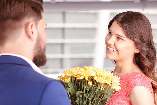 istock Man presenting flowers to his girlfriend 485082036