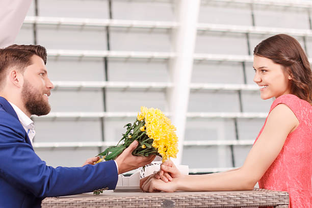 istock Handsome man giving flowers to his girlfriend 485082044