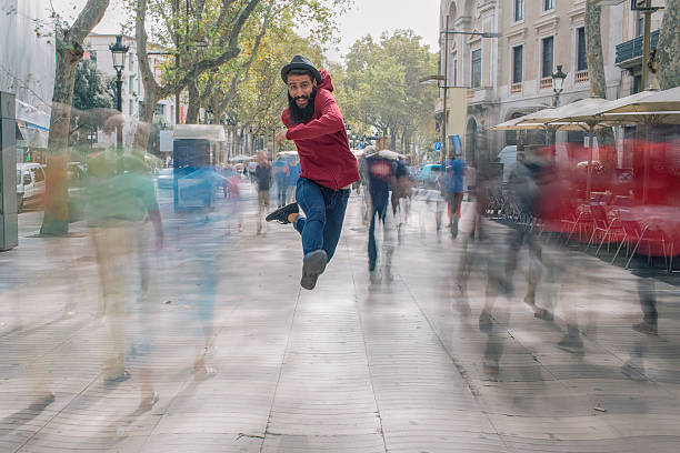 Young guy jumping in the air in the Ramblas, Barcelona