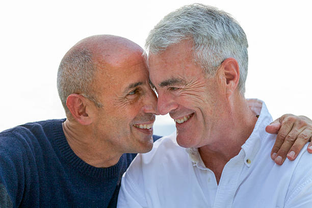 Senior Gay Male Couple Smiling, Affectionate, and In Love stock photo