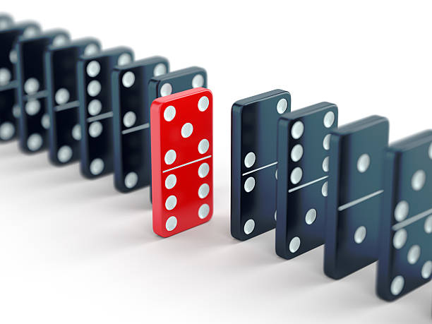 istock Red domino tile among black ones 485100358