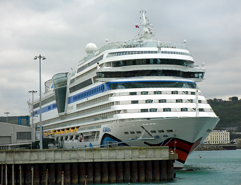 Dover, United Kingdom - October 04, 2011: The cruise ship AIDAblu by AIDA Cruises has moored in the port of Dover. It was on a 7-night cruise with the route: Hamburg (Germany) - At sea - Le Havre (France) - Dover (UK) - Antwerp (Belgium) - Rotterdam (Netherlands) - At sea - Hamburg (Germany). AIDA Cruises is a branch of the Italian company Costa Crociere SpA, which is part of the cruise company Carnival Corporation & plc.