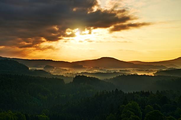 istock lighted rocks and hills bellow sunset sun on  horizon. Silhouettes. 485106958
