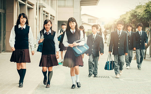 First day of school in Japan Japanese teenage students in uniforms walking back to School child japanese culture japan asian ethnicity stock pictures, royalty-free photos & images