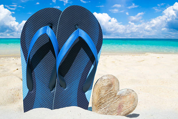 istock Blue flip flops and wooden heart 485110228