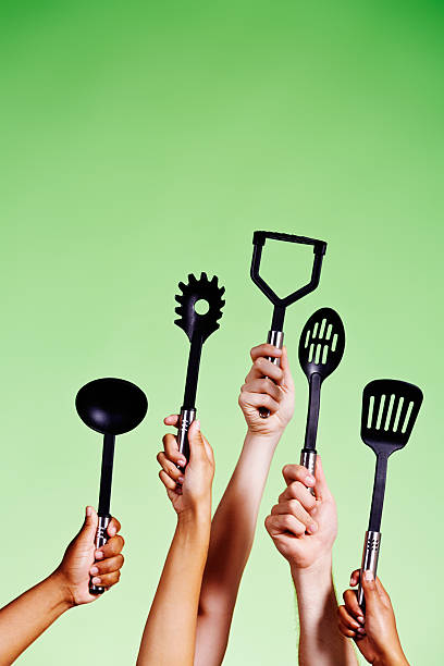 istock I'll cook! Five hands with kitchen utensils volunteering 485112251