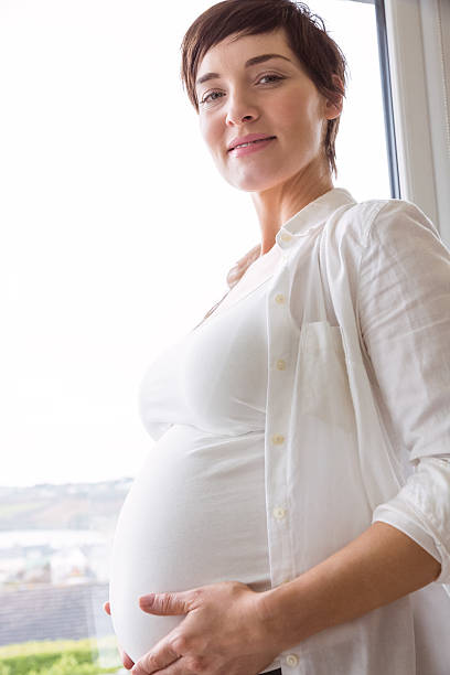istock Pregnant woman holding her bump 485112602
