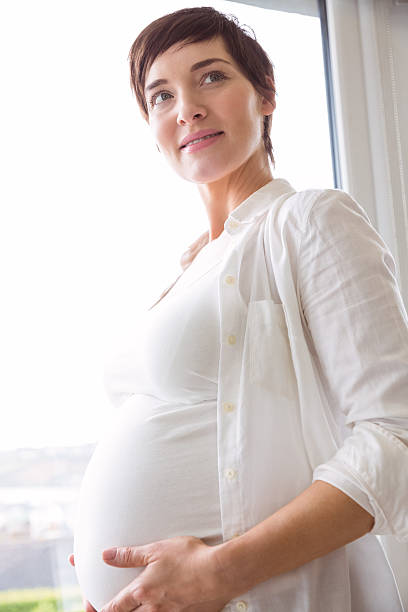 istock Pregnant woman holding her bump 485112612